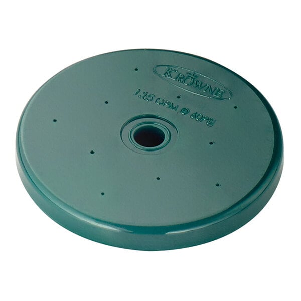 A round, green disc with a central hole, several small holes around it, and embossed text on the surface.