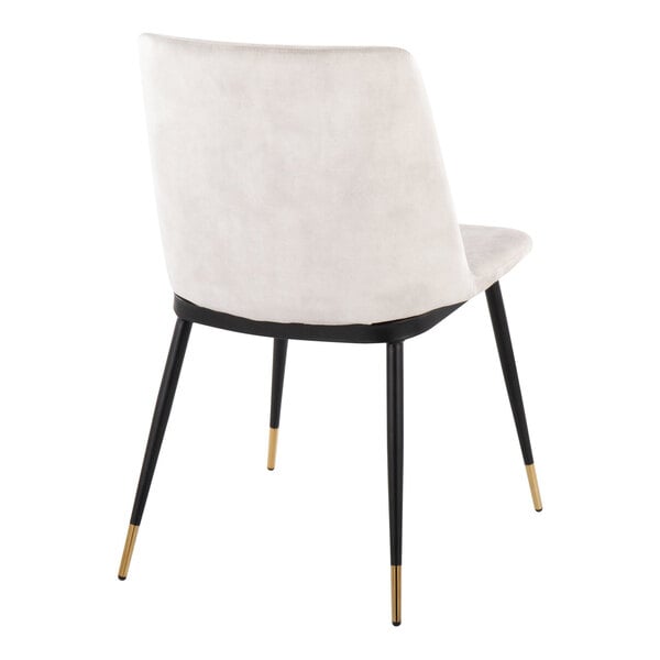 A modern chair with a beige velvet back and seat, black metal legs, and gold-colored tips, shown from the rear angle.
