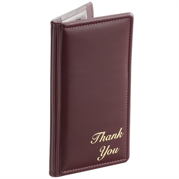 A burgundy check presenter with gold 'Thank You' text on the front and visible stitching along the edges.