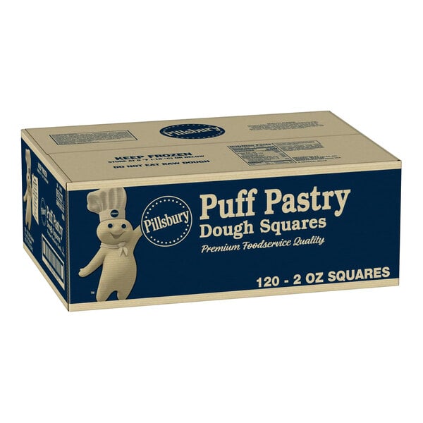 A cardboard box labeled 'Pillsbury Puff Pastry Dough Squares' with an illustration of the Pillsbury Doughboy and product details printed on the side.