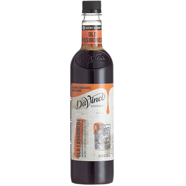 A bottle filled with dark liquid, featuring a white and orange label with the text 'Old Fashioned' and 'DaVinci Gourmet.'