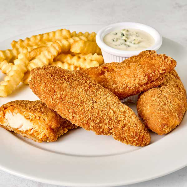 A plate with breaded chicken tenders, crinkle-cut French fries, and a small cup of dipping sauce.