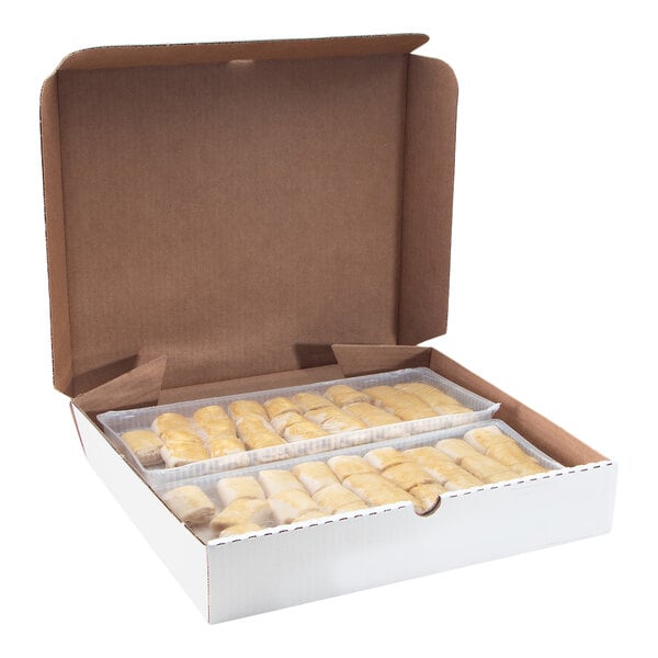 An open cardboard box containing rows of small, golden-brown croissants arranged in trays.