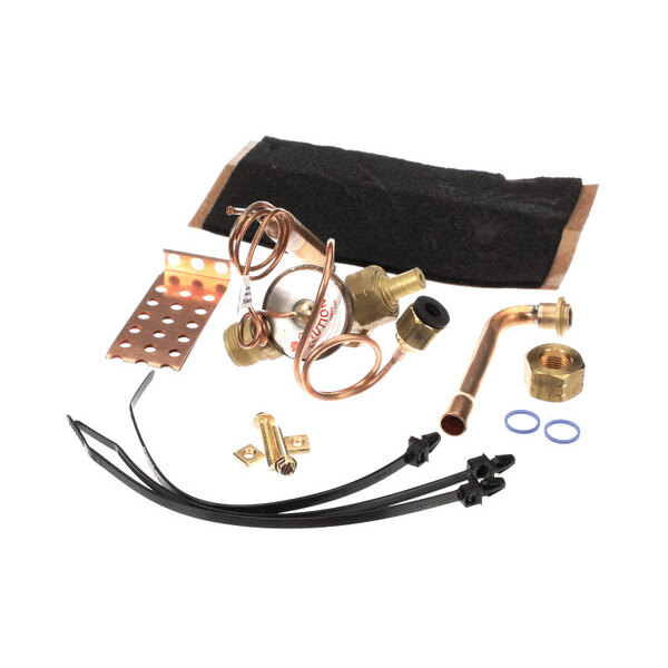 A collection of various metal and plastic components, including copper tubing, brass fittings, a perforated metal bracket, zip ties, and small hardware, arranged on a white background.