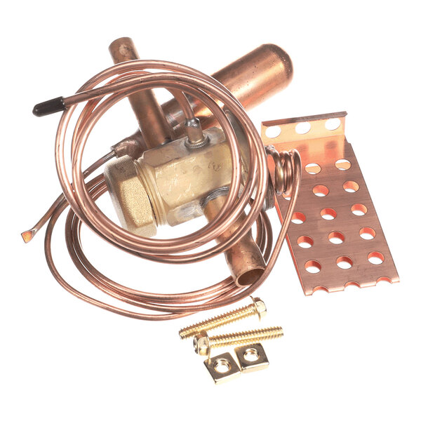 A collection of copper and brass components, including coiled tubing, a valve, a perforated metal bracket, and mounting hardware.