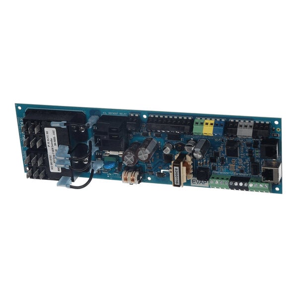A rectangular electronic circuit board with various components including capacitors, connectors, relays, and terminal blocks mounted on it.