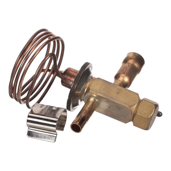A brass and copper mechanical component with coiled tubing and a metal clip, likely part of a refrigeration or HVAC system.