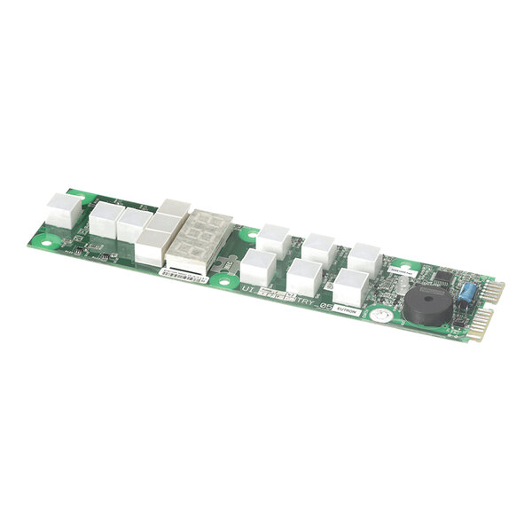 A green electronic circuit board with multiple white rectangular components and various other electronic parts mounted on it.