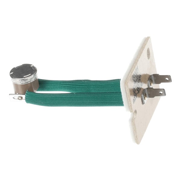 A metal switch component with two green wires attached to a small metal canister and a rectangular mounting plate with two metal prongs.