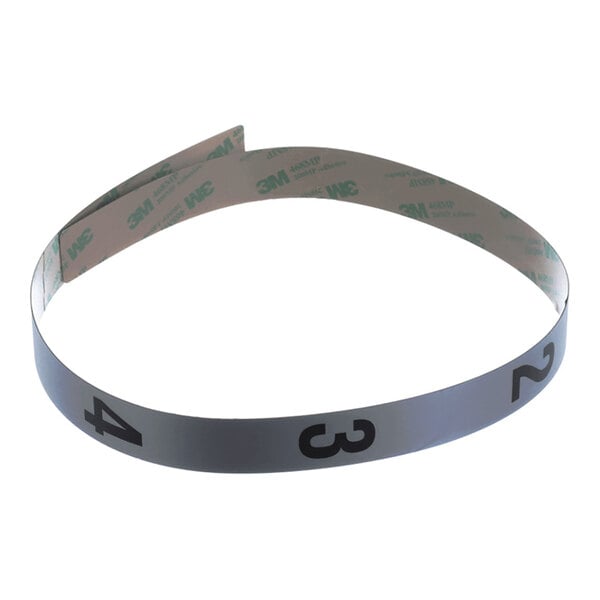 A metallic strip with adhesive backing and large black numbers (2, 3, 4) printed on its surface.