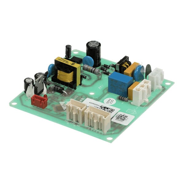 A green printed circuit board (PCB) with various electronic components, including capacitors, connectors, resistors, and a transformer, mounted on its surface.