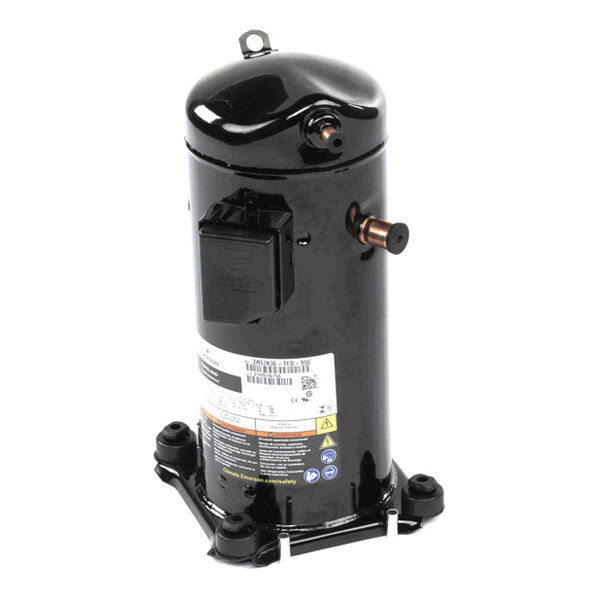 A black cylindrical mechanical component with copper pipe fittings, a label, and mounting feet, likely a compressor unit.