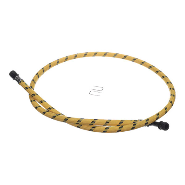 A yellow hose with black diagonal stripes and black connectors at both ends, arranged in a circle with two small metal clips placed inside the loop.