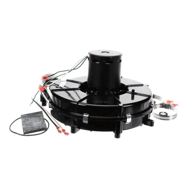 A black mechanical component with attached wires, metal clamps, and additional small parts, likely part of an exhaust blower assembly.