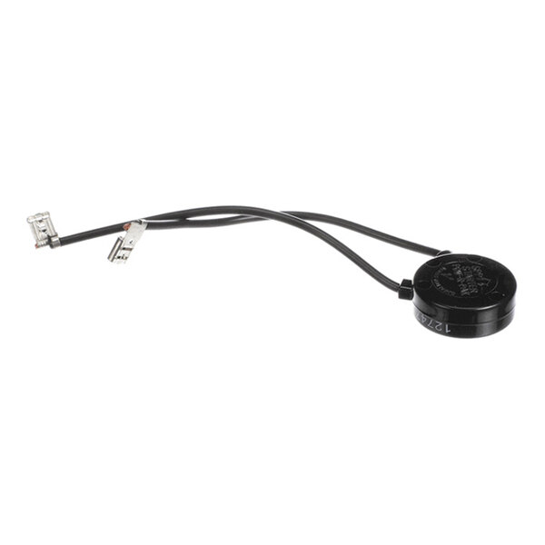 A small black circular electronic component with two attached black wires ending in metal connectors.
