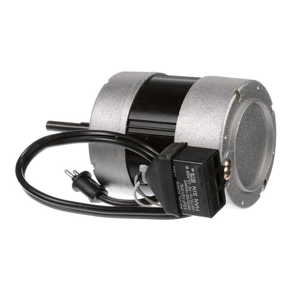 A cylindrical electric motor with a metallic housing, attached power cord, and a black electrical component.
