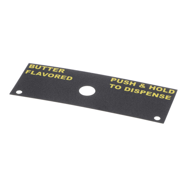 A rectangular black decal with yellow text reading 'BUTTER FLAVORED' on the left and 'PUSH & HOLD TO DISPENSE' on the right, featuring a central circular hole and two smaller holes on either side.
