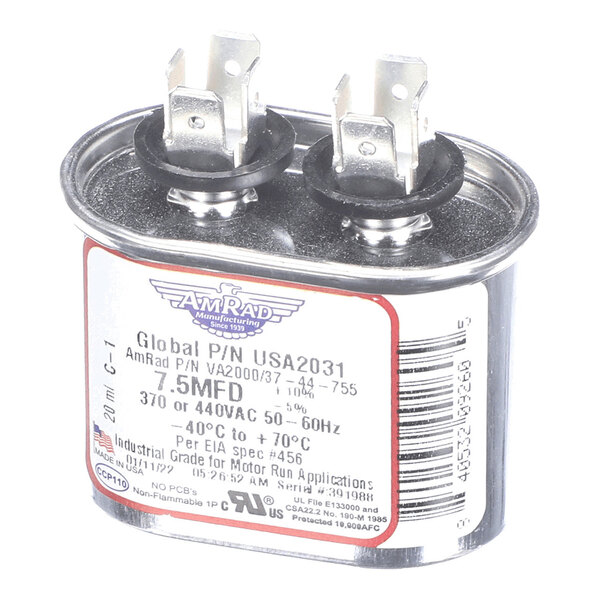 A metallic oval-shaped capacitor with two terminal posts and a label displaying technical specifications.