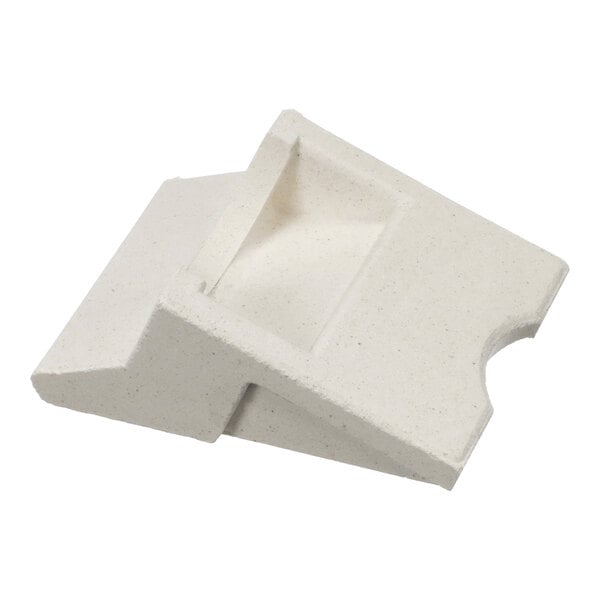 A white, angular ceramic or stone-like object with a sloped surface and a recessed rectangular area.