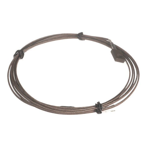 A coiled, brown, braided cable with a small rectangular block attached to one end.