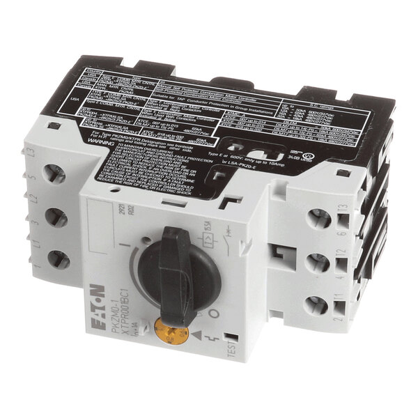 A rectangular electrical component with a rotary switch, labeled terminals, and technical information printed on the top surface.