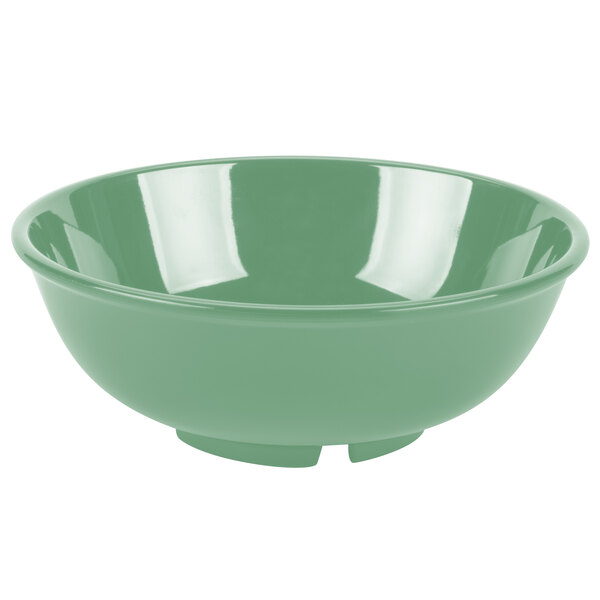 A close up of a rainforest green GET Diamond Mardi Gras melamine bowl with a white rim.