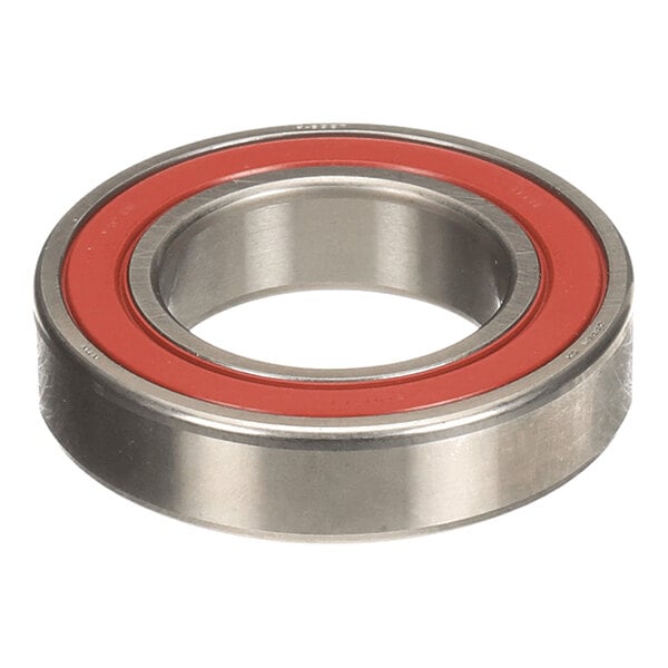 A metal circular bearing with a red inner ring, viewed from an angle.