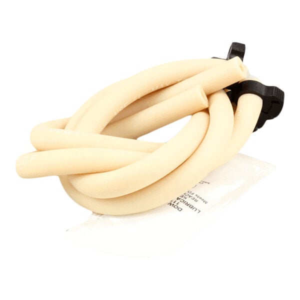 A coiled beige rubber tube with black plastic connectors and a small clear packet, likely containing lubricant or instructions.