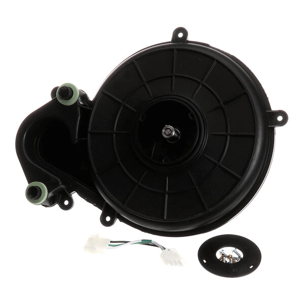 A black circular mechanical component with attached wiring and a separate round part, likely part of an assembly kit.