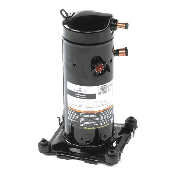 A black cylindrical mechanical component with copper pipe fittings and a label, mounted on a square metal base.