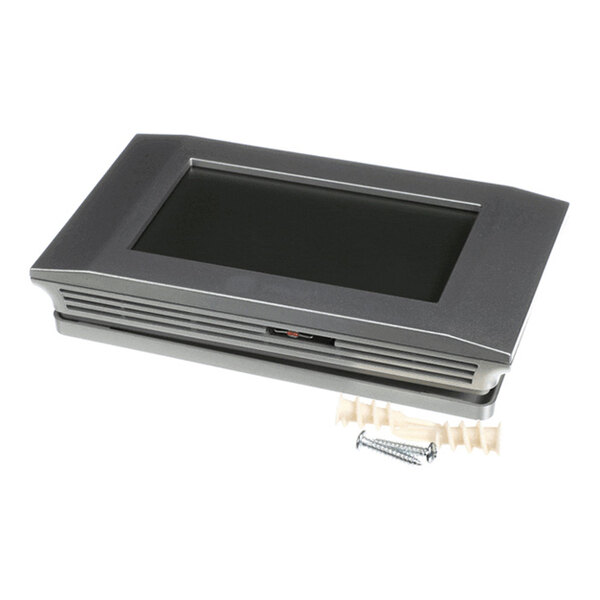 A rectangular electronic device with a dark screen, metallic frame, and vent-like grooves, accompanied by wall anchors and screws.