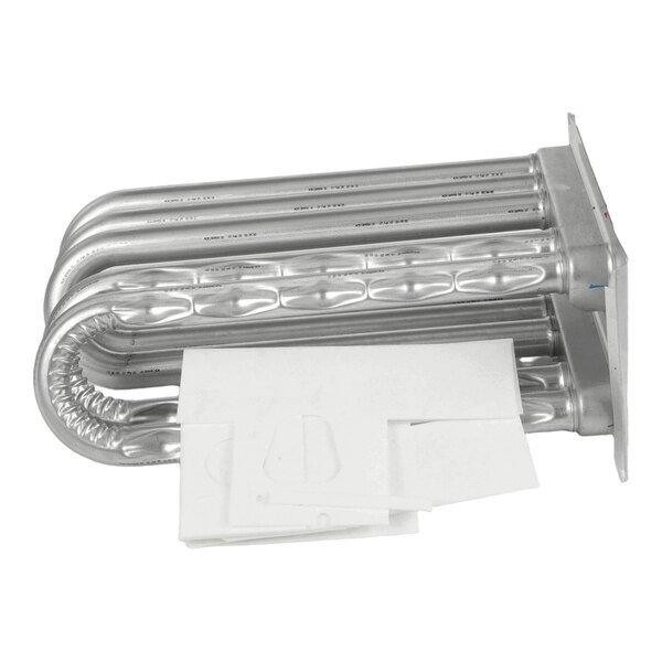 A metallic, tubular heat exchanger with several curved pipes and a flat mounting plate, accompanied by white paper sheets placed on top.