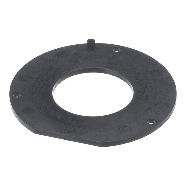 A black, circular, flat ring with a large central hole and several smaller holes around its perimeter, featuring a small raised peg on one side.