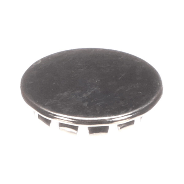 A round, black, flat-topped object with a smooth surface and segmented edges, resembling a plug or cap.