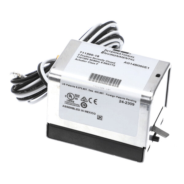 A metal electrical actuator with attached wires and a label displaying technical specifications and certification marks.