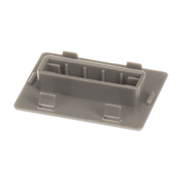 A rectangular, gray plastic component with a raised, hollow center and flat base, featuring several small tabs and slots.
