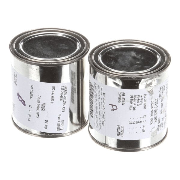 Two small metal cans with white labels and black text, viewed from an angle.