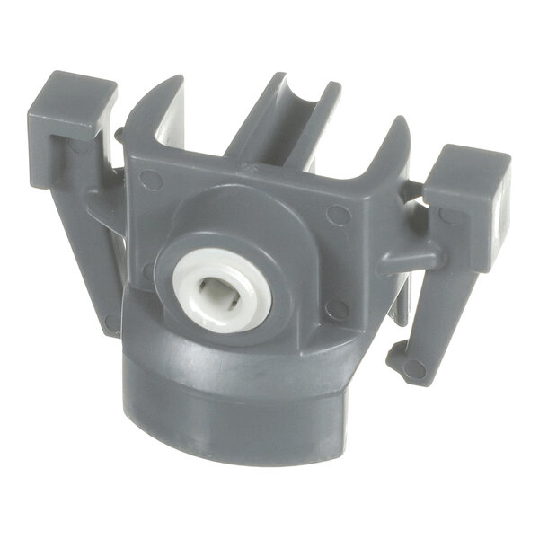 A gray plastic component with a central circular opening and two side arms, likely a cap or connector part.