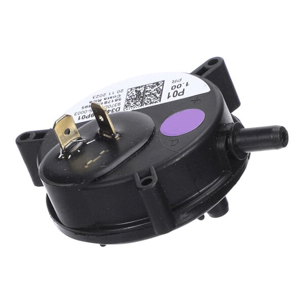 A round black plastic component with two metal terminals, a purple dot, a nozzle, and a label with a QR code and text.