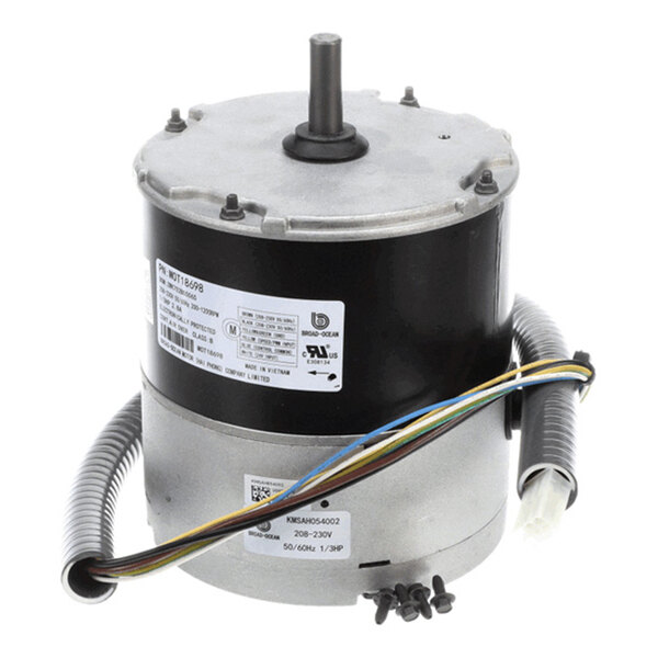 A cylindrical electric motor with a central shaft, attached wires, and identification labels on its body.