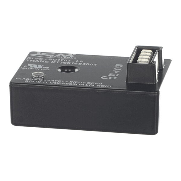 A black rectangular electronic module with a connector and printed labels on the top surface.