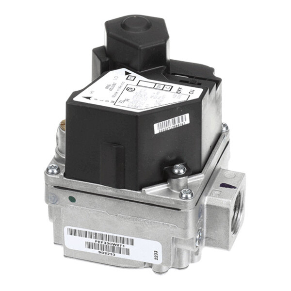 A metal and plastic gas valve component with labels and threaded pipe connections visible.