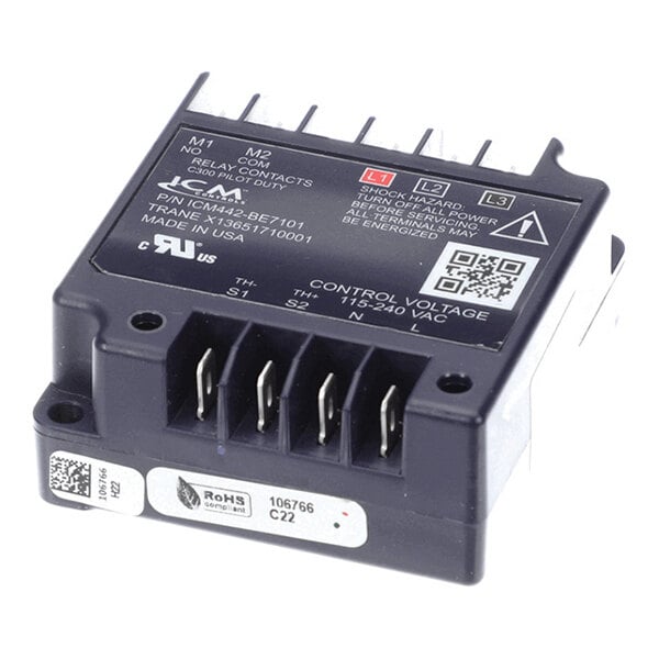 A black electronic module with multiple labeled terminals and a printed label indicating control voltage and safety warnings.