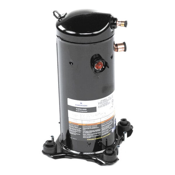 A black cylindrical mechanical component with copper pipe fittings and a label, mounted on a metal base.