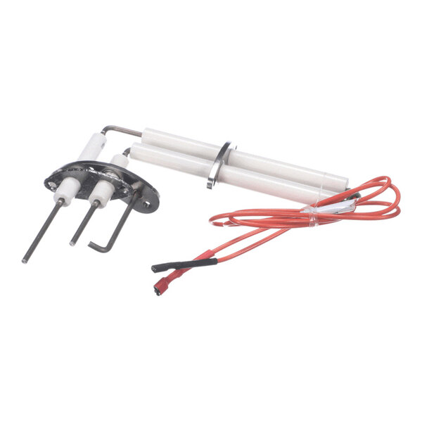 A metal and ceramic component with two prongs, a mounting plate, and attached red electrical wires.