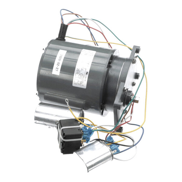 A cylindrical electric motor with attached wires, capacitors, and a mounting bracket.