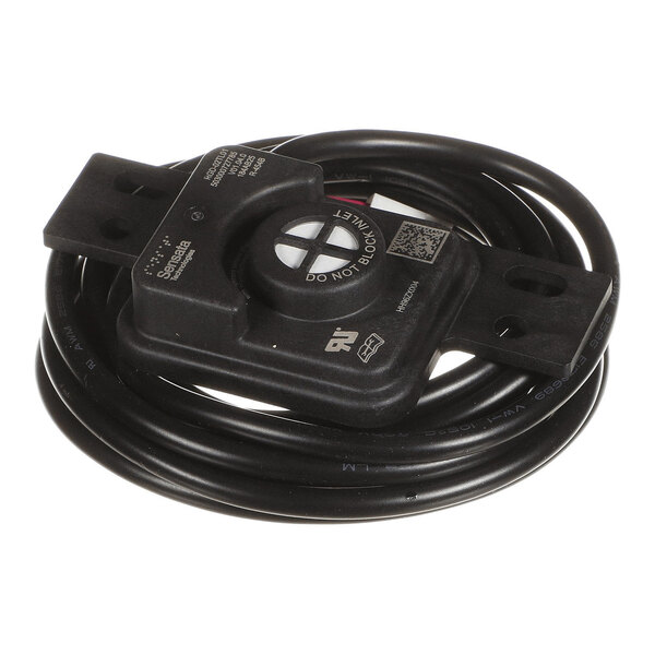 A black electronic sensor device with an attached coiled cable and mounting brackets on each end.