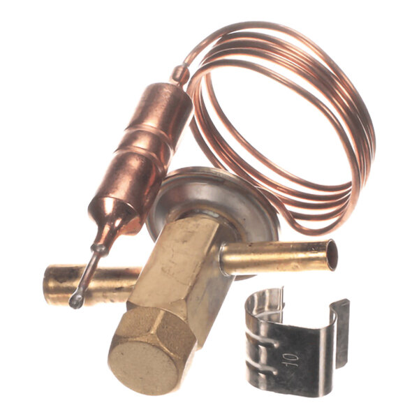 A brass and copper mechanical component with a coiled tube and a metal clip, likely part of a refrigeration or HVAC system.