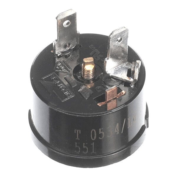 A round black electrical component with three metal prongs and a central brass connector on top.