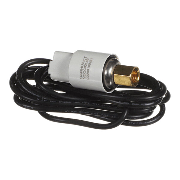 A small cylindrical device with a brass threaded fitting, attached to a long black cable, and labeled with technical information.
